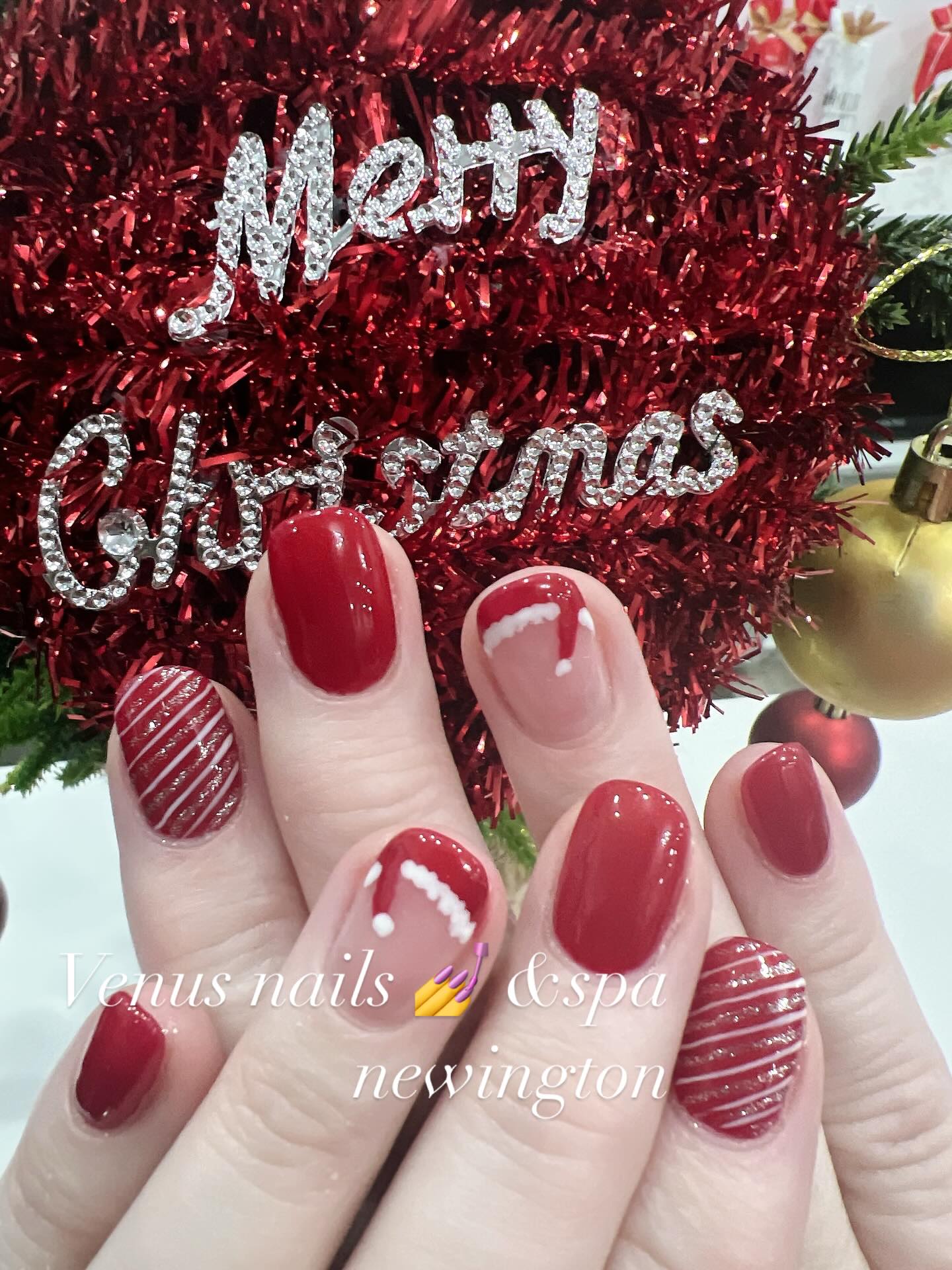 Red Christmas manicure with santa hats and candy cane